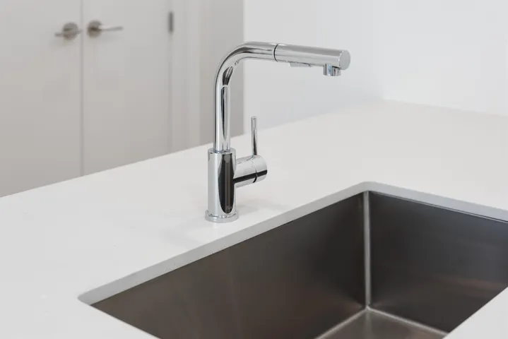 Detailed view of a sink and light countertops