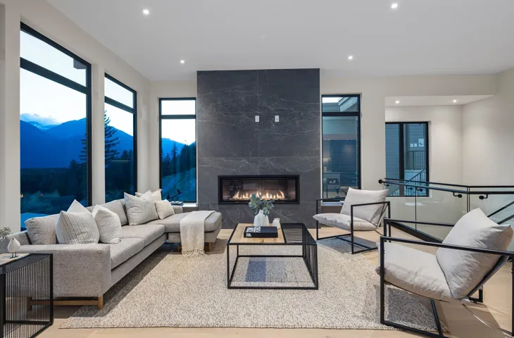 Living area with a mountain view, wood finished floors, recessed lighting, and a high end fireplace