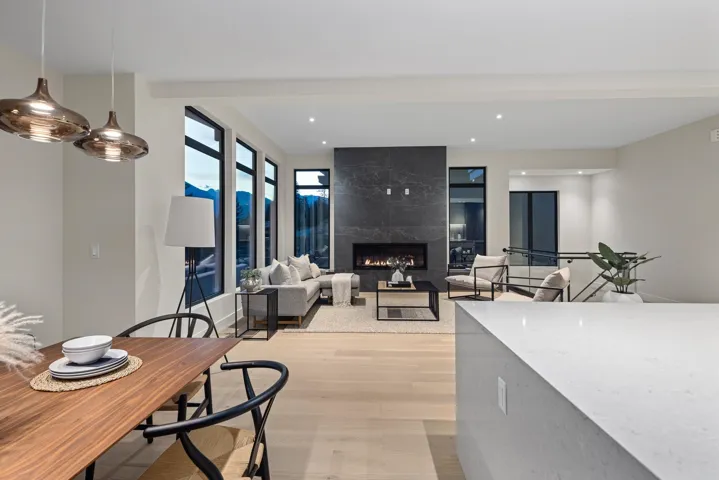 Dining room with light wood-style flooring, a high end fireplace, and recessed lighting