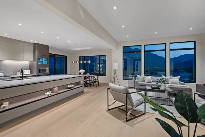Living room with light wood-style flooring, a mountain view, and recessed lighting