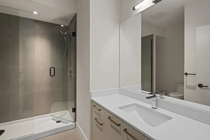 Bathroom featuring vanity and a stall shower