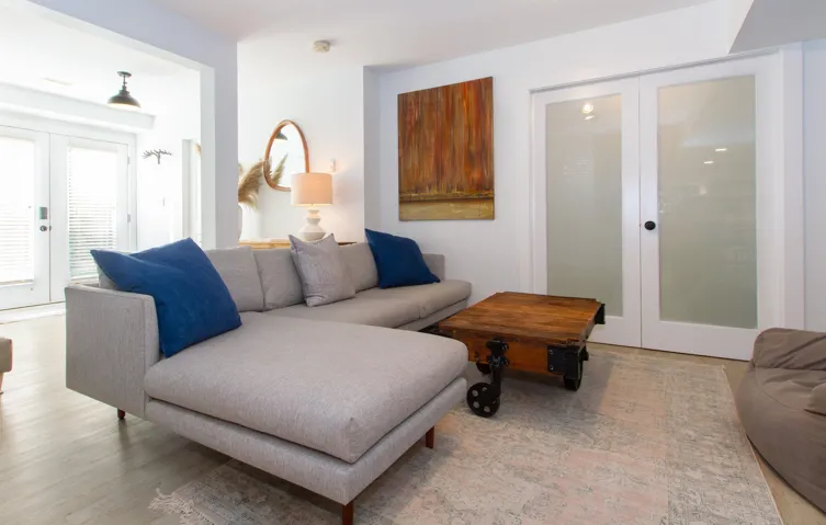 Living area featuring light wood-finish flooring and a light-toned area rug