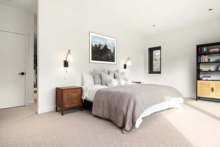 Bedroom featuring light colored carpet and baseboards