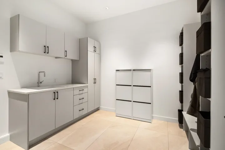 Interior space featuring light countertops, a sink, light tile patterned floors, and baseboards