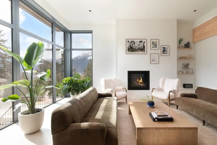 Living room with a glass covered fireplace and a mountain view