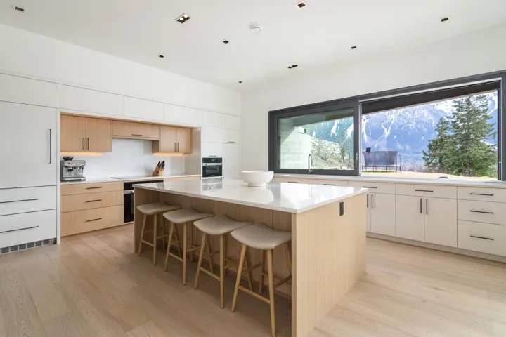 Kitchen featuring wall oven, a kitchen bar, tasteful backsplash, light wood-style floors, and a center island
