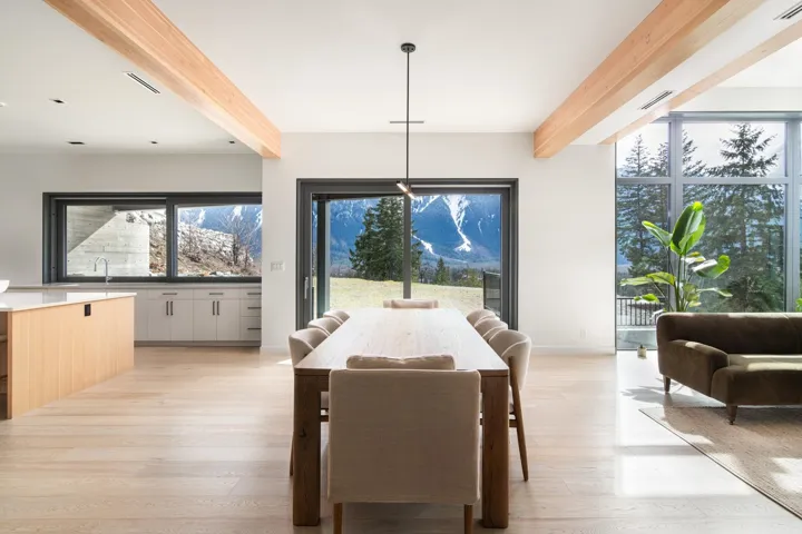 Dining space featuring light wood-style flooring, beam ceiling, and baseboards