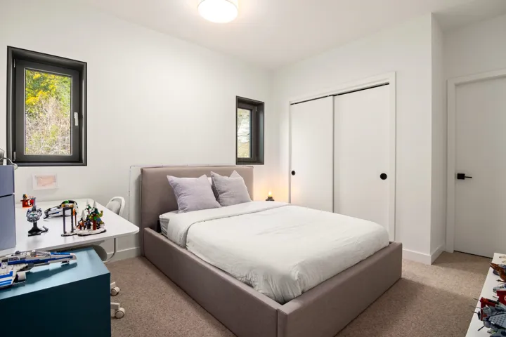 Carpeted bedroom featuring baseboards and a closet