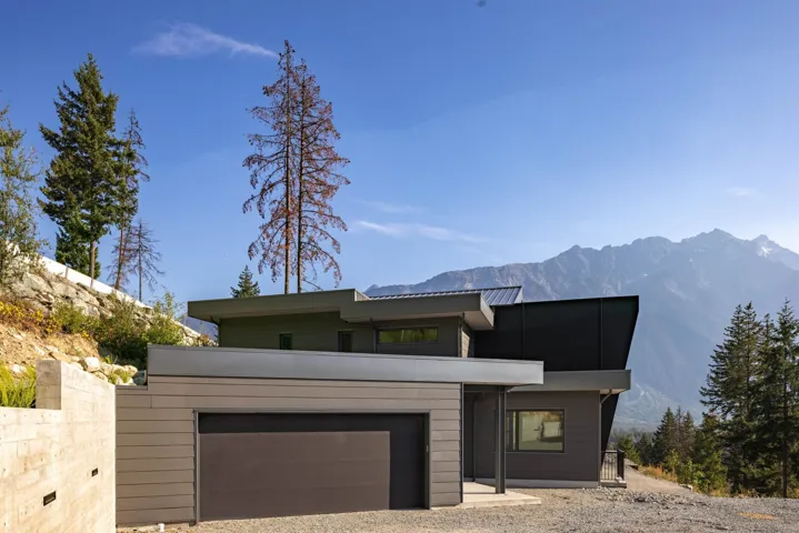 Modern home with driveway, a garage, and a mountain view