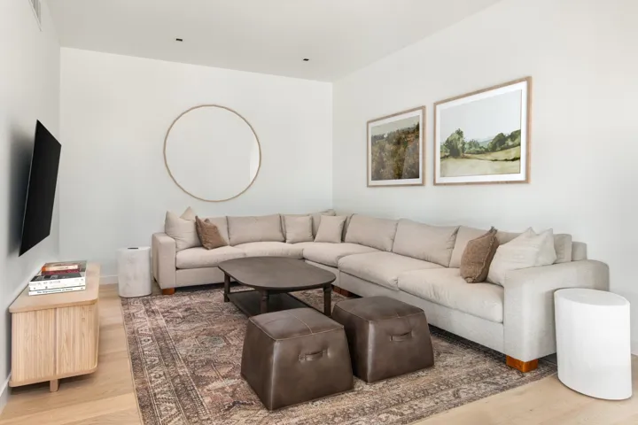 Living area featuring light wood finished floors and visible vents