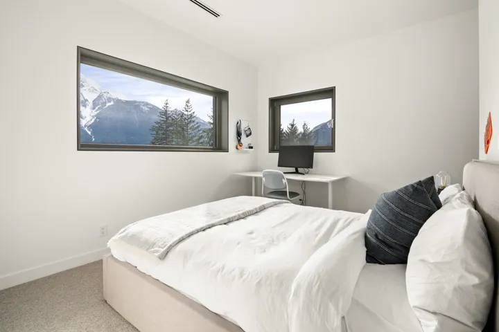 Carpeted bedroom with baseboards and visible vents