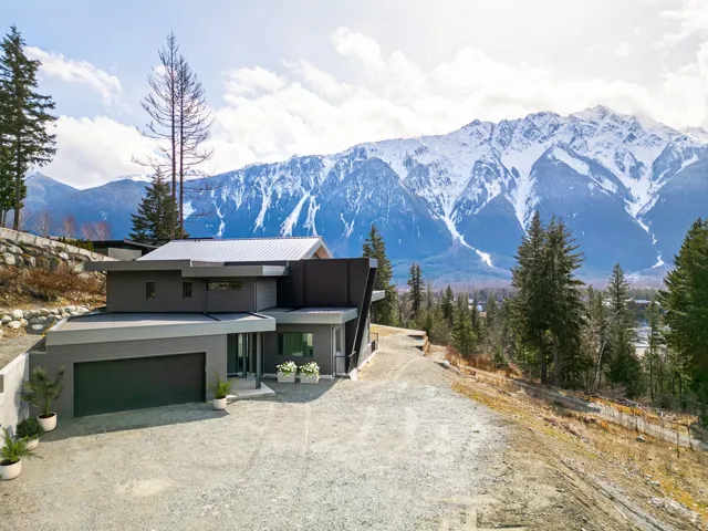 View of front of house featuring metal roof, gravel driveway, and a mountain view