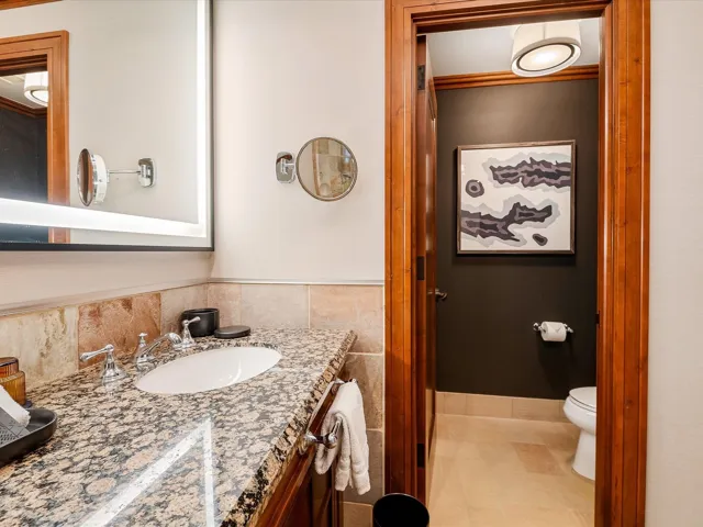 Bathroom featuring toilet, vanity, and tile patterned flooring