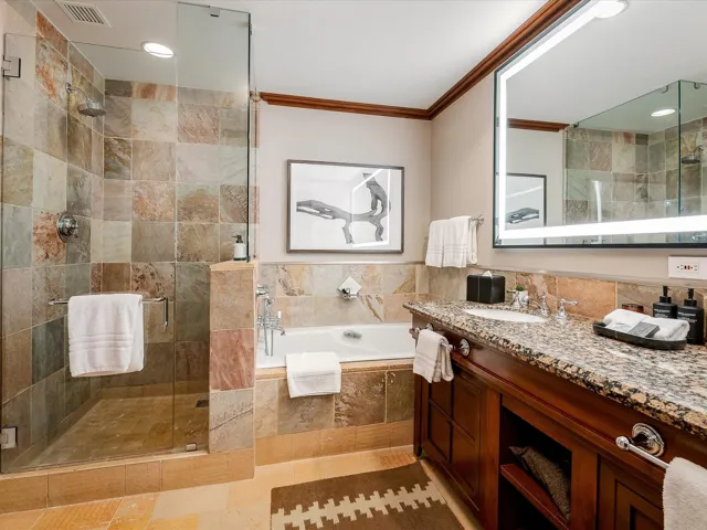 Bathroom with visible vents, a bath, crown molding, vanity, and a stall shower