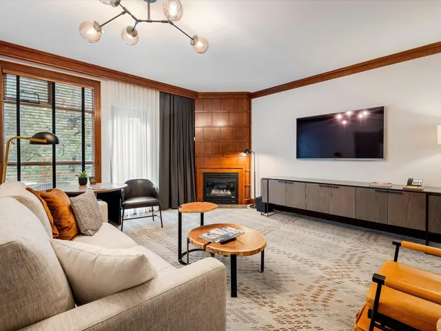 Living room with a large fireplace and ornamental molding