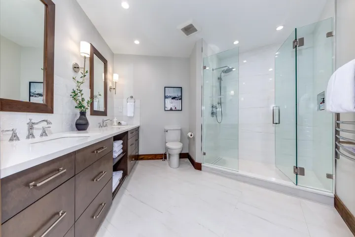Bathroom featuring double vanity, a stall shower, tasteful backsplash, recessed lighting, and light tile patterned floors