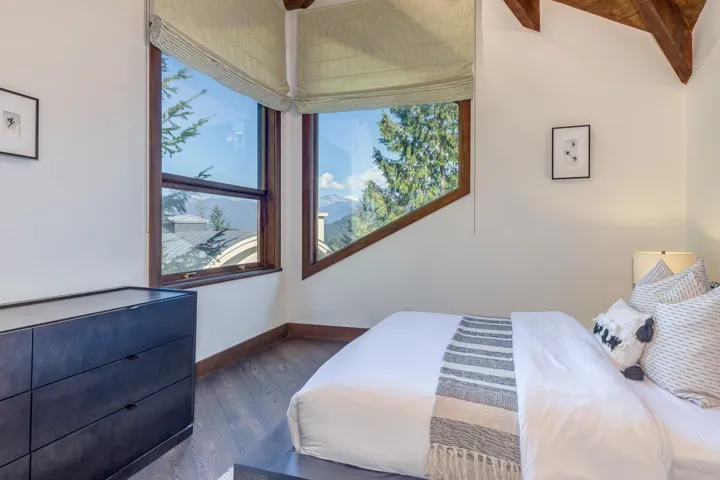 Bedroom featuring dark wood-type flooring and baseboards