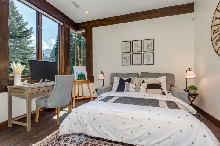Bedroom featuring wood finished floors and beamed ceiling