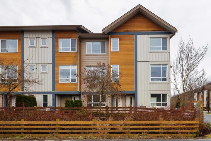 View of front facade featuring a fenced front yard and board and batten siding