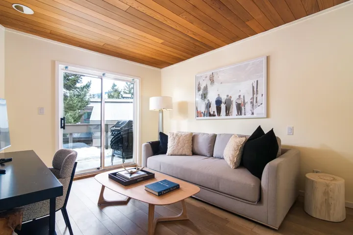 Living area with wooden ceiling and wood finished floors