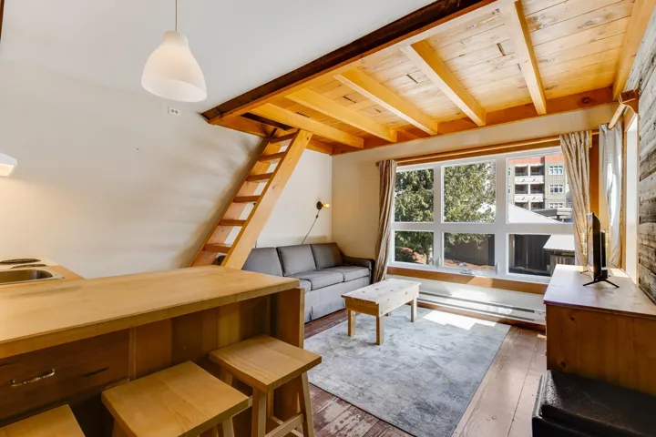 Living area featuring hardwood / wood-style floors, wood ceiling, and beam ceiling