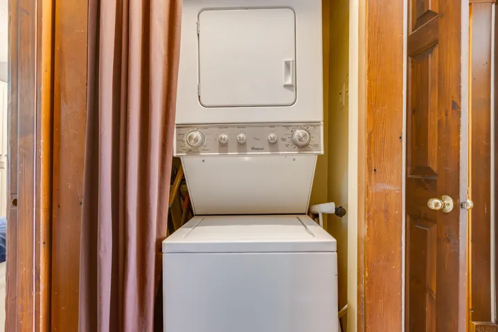 Laundry area with stacked washer / dryer and laundry area