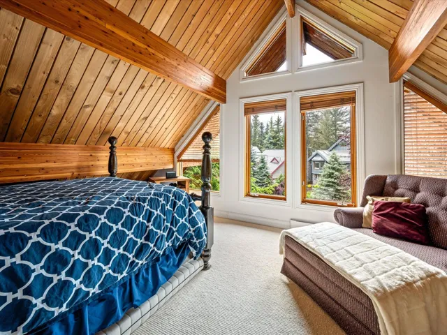 Carpeted bedroom featuring wood ceiling