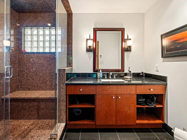 Bathroom featuring vanity and a stall shower