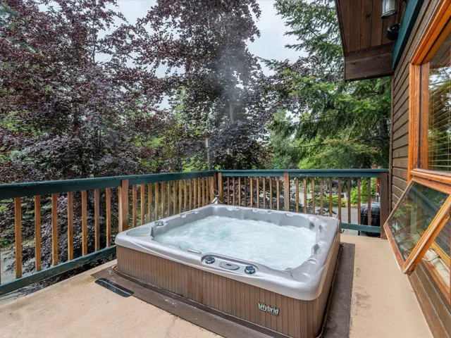 View of patio with a hot tub