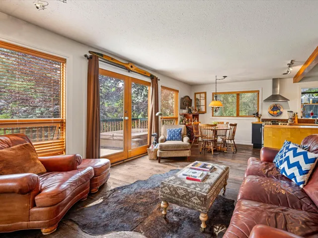 Living area with a textured ceiling, wood finished floors, and french doors