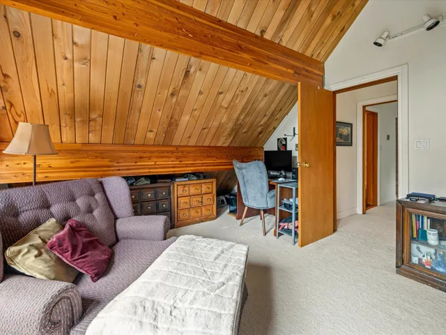 Carpeted office featuring vaulted ceiling and wood ceiling