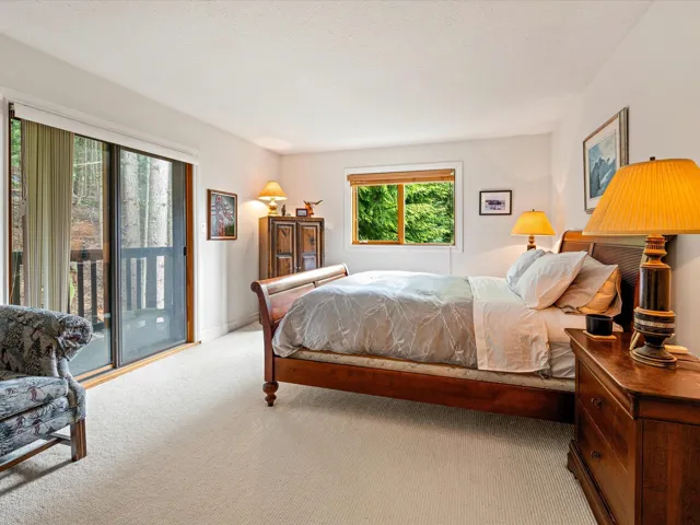 Bedroom with access to exterior and carpet flooring