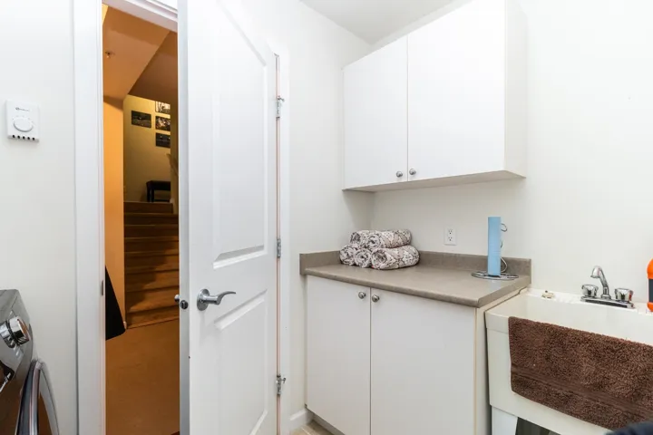 Laundry room featuring a sink and washer / clothes dryer