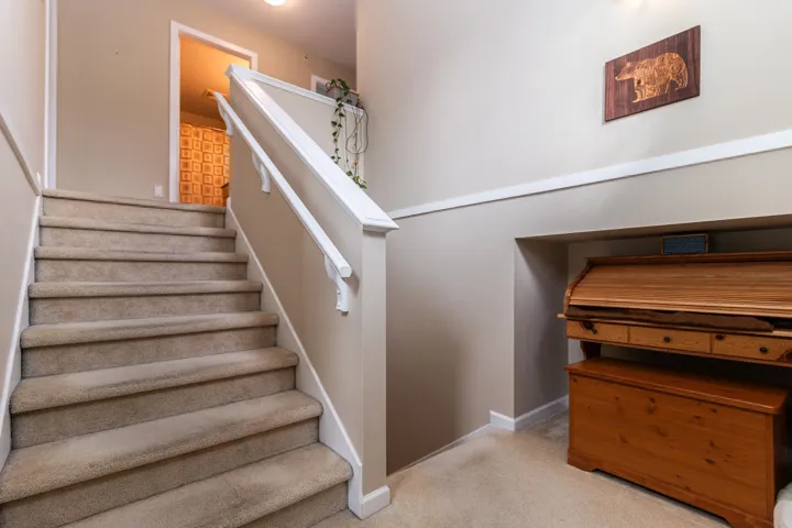 Stairway featuring baseboards and baseboard heating