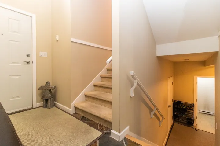 Stairway featuring baseboards and baseboard heating
