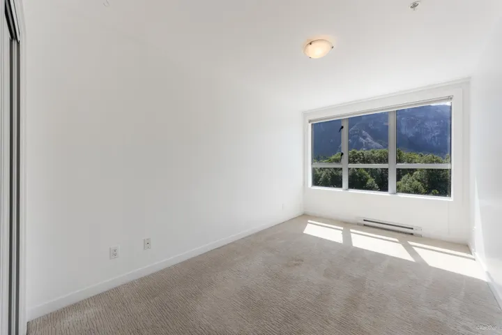 Spare room with baseboard heating, carpet floors, and baseboards