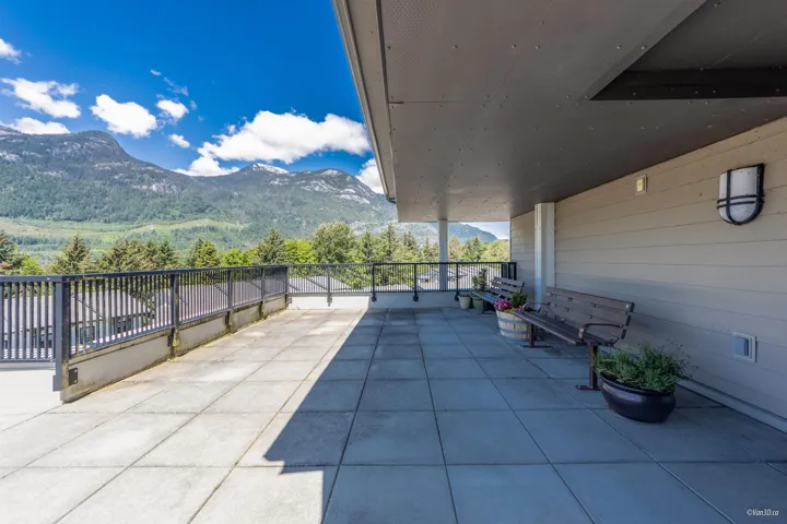 View of patio with a mountain view and a balcony