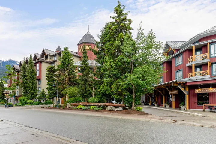 Multi-story building featuring a prominent corner tower and natural wood accents