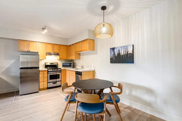 Full kitchen featuring wood cabinetry, stainless steel appliances, and light wood-finish flooring