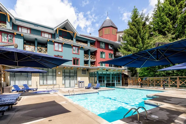 Outdoor swimming pool surrounded by a concrete patio