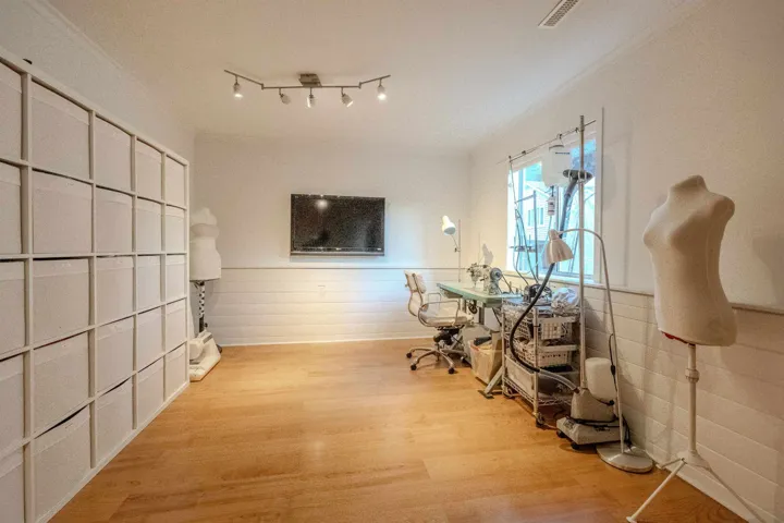 Office area with light wood-style flooring and wainscoting