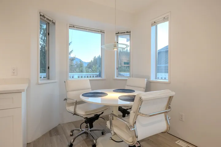Dining space with light wood-style flooring and healthy amount of natural light