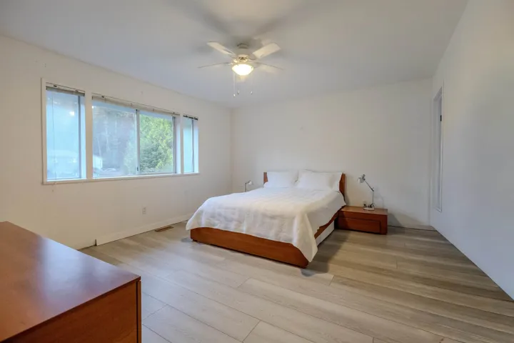 Bedroom with light wood-style flooring and a ceiling fan