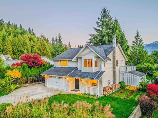 Traditional home with concrete driveway, board and batten siding, a shingled roof, a chimney, and a garage