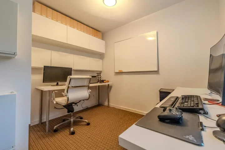 Office space featuring baseboards and light colored carpet