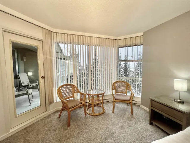 Living area with carpet floors and baseboards