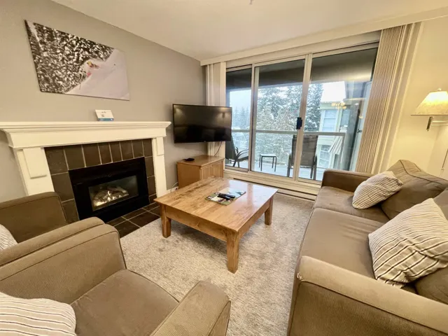 Living room featuring a tile fireplace and carpet