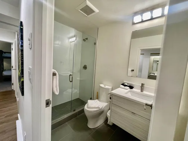 Bathroom featuring visible vents, toilet, a shower stall, vanity, and tile patterned floors