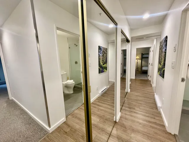 Hallway with light wood-type flooring and baseboards