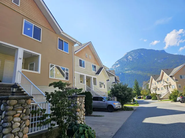 View of asphalt road featuring stairs, a mountain view, and a residential view